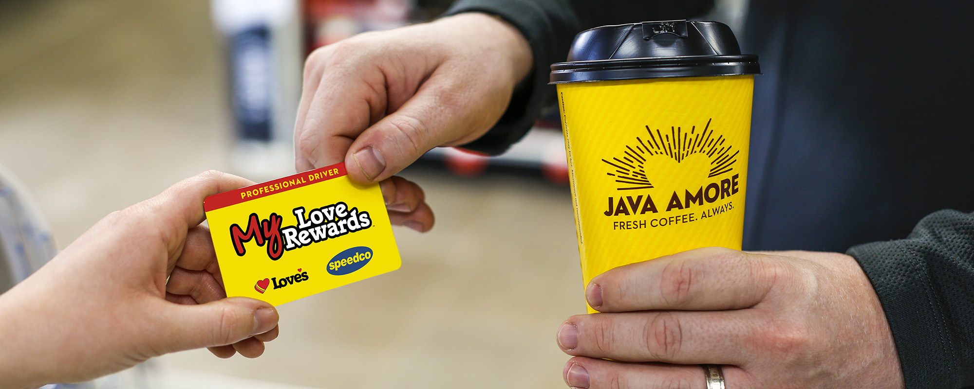 MLR card being handed from a customer to a cashier with a Love's Coffee cup